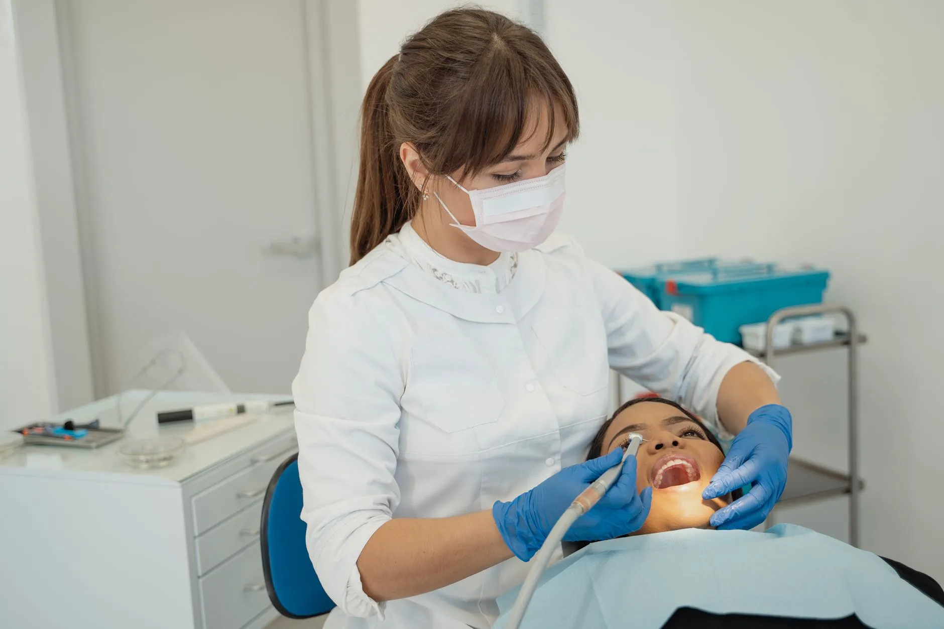 Smiling new patient talking with a dentist during a first dental exam at a Round Rock, TX dental office