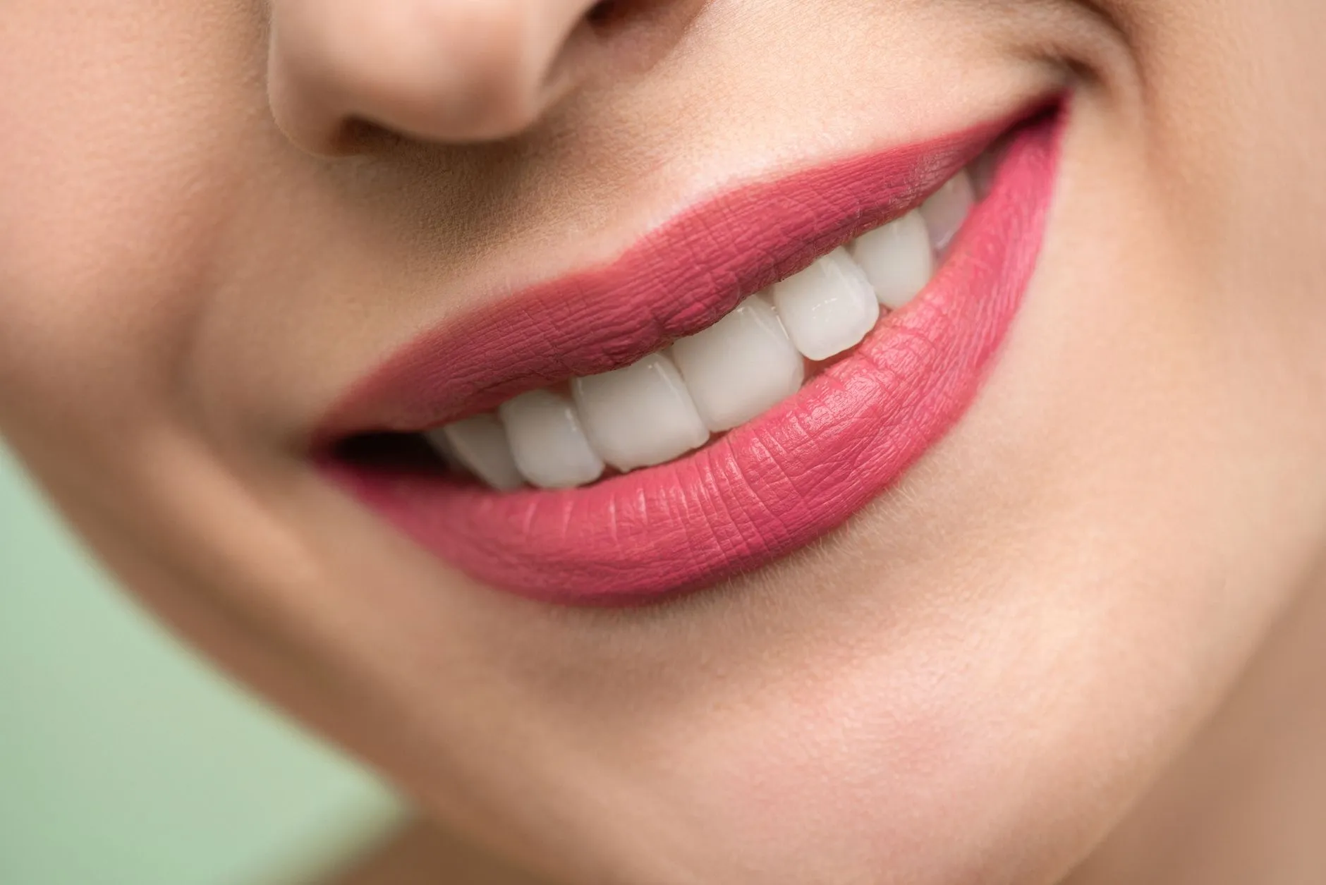 Smiling woman with a bright, even smile posing for a fall family photo after cosmetic dentistry in Round Rock, TX