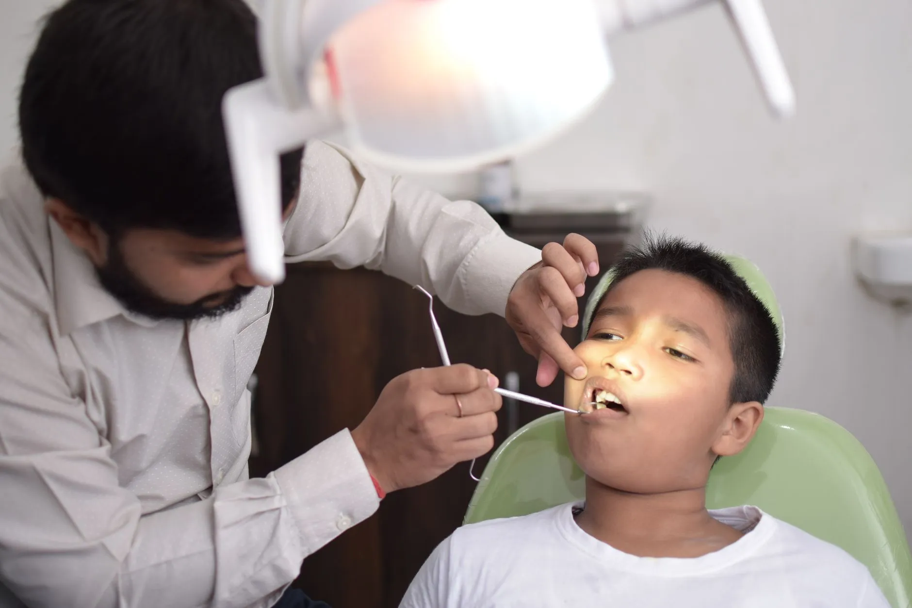 Friendly dentist welcoming a new patient in a bright, modern dental office in Round Rock, TX