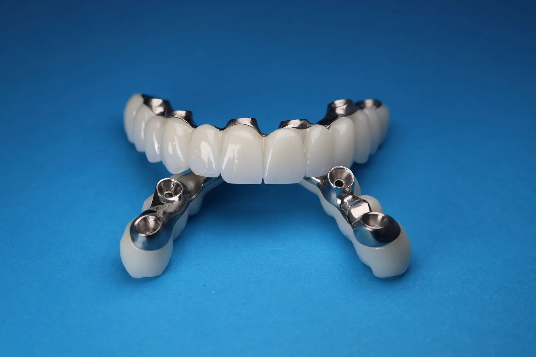 Dentist showing a patient a dental implant model during a fall consultation in Round Rock, TX